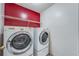 Convenient laundry room features a washer, a dryer, and overhead storage shelves at 12384 Riviera Dr, Fayetteville, GA 30215