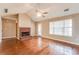 Comfortable living room boasts a cozy brick fireplace, ceiling fan and backyard access at 12384 Riviera Dr, Fayetteville, GA 30215