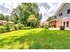 Expansive backyard featuring lush lawn, mature trees, and private patio of the home at 3755 Greentree Dr, Decatur, GA 30032