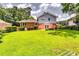 A large backyard with a lush green lawn and mature trees providing ample shade at 3755 Greentree Dr, Decatur, GA 30032