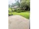 View of back yard and patio with house in the distance at 3755 Greentree Dr, Decatur, GA 30032