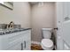 Well-lit bathroom with granite countertop vanity, neutral walls, and classic toilet at 3755 Greentree Dr, Decatur, GA 30032