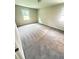 Bright bedroom with neutral walls, plush gray carpet, and natural light from two windows at 3755 Greentree Dr, Decatur, GA 30032