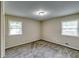 Neutral bedroom with two large windows and carpet flooring at 3755 Greentree Dr, Decatur, GA 30032