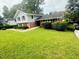 Charming two-story home with a brick-and-siding exterior and well-manicured landscaping at 3755 Greentree Dr, Decatur, GA 30032