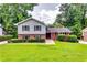 Charming home featuring a well-manicured lawn, a mix of brick and gray siding, and mature trees at 3755 Greentree Dr, Decatur, GA 30032