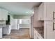 Modern kitchen showcasing white cabinets, granite countertops, and a view to the living area at 3755 Greentree Dr, Decatur, GA 30032