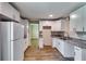 Bright kitchen features new white cabinets, granite countertops, and stainless steel appliances at 3755 Greentree Dr, Decatur, GA 30032