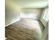 Open-concept living room with wood-look flooring and abundant natural light at 3755 Greentree Dr, Decatur, GA 30032