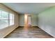 Living room with hardwood floors, neutral walls, and window with natural light at 3755 Greentree Dr, Decatur, GA 30032