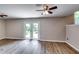 Cozy living room with a ceiling fan and doors that lead to the backyard at 3755 Greentree Dr, Decatur, GA 30032