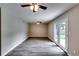 Spacious living room featuring modern ceiling fans, gray walls, and a door to the backyard at 3755 Greentree Dr, Decatur, GA 30032