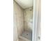 Shower stall with tiled walls, modern showerhead, and a built-in shelf at 3755 Greentree Dr, Decatur, GA 30032