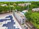 Aerial view of the modern townhome showcasing a rooftop deck, solar panels, and nearby street at 417 E College Ave # 302, Decatur, GA 30030