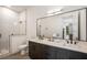 This bathroom features double sinks, a huge mirror and a glass enclosed shower at 417 E College Ave # 302, Decatur, GA 30030