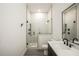 This bathroom features a glass door shower, large tiles and an updated sink and faucet at 417 E College Ave # 302, Decatur, GA 30030