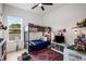 Bright bedroom features a bunk bed, modern ceiling fan, large window with natural light, and light colored wood flooring at 417 E College Ave # 302, Decatur, GA 30030