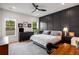 This primary bedroom boasts a statement wall, a ceiling fan, and natural light from the windows at 417 E College Ave # 302, Decatur, GA 30030