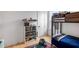 This bedroom features a bunk bed, wood floors and shelves of Lego sets, a great space for children at 417 E College Ave # 302, Decatur, GA 30030