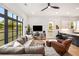 Open-concept living room featuring comfortable sofa, large windows, and modern finishes at 417 E College Ave # 302, Decatur, GA 30030