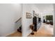 Open-concept living space with wood floors, staircase, decorative artwork and comfortable seating arrangement at 417 E College Ave # 302, Decatur, GA 30030