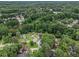 Aerial view of a wooded neighborhood showcasing houses with mature trees at 4835 Kellys Mill Nw Dr, Lilburn, GA 30047