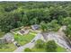 Aerial view of the house with fenced backyard surrounded by mature trees at 4835 Kellys Mill Nw Dr, Lilburn, GA 30047