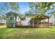 Back exterior view shows the porch, deck, and stairs leading to a grassy yard at 4835 Kellys Mill Nw Dr, Lilburn, GA 30047