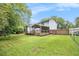 Back exterior view shows a porch and deck overlooking the green backyard at 4835 Kellys Mill Nw Dr, Lilburn, GA 30047