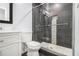Elegant bathroom with a glass shower featuring dark tiling and modern fixtures at 4835 Kellys Mill Nw Dr, Lilburn, GA 30047