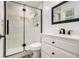 Stylish bathroom featuring a glass-enclosed shower with marble tiling, modern fixtures, and a vanity with drawers at 4835 Kellys Mill Nw Dr, Lilburn, GA 30047