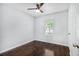 This bedroom is filled with natural light and features hardwood floors and a ceiling fan at 4835 Kellys Mill Nw Dr, Lilburn, GA 30047
