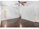 A well-lit bedroom features hardwood floors, ceiling fan, and an ensuite bathroom with glass shower doors at 4835 Kellys Mill Nw Dr, Lilburn, GA 30047