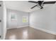 Bedroom with painted concrete floors, a ceiling fan, and two windows bringing in natural light at 4835 Kellys Mill Nw Dr, Lilburn, GA 30047