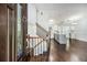 Welcoming foyer featuring wood floors and staircase leading to the upper level at 4835 Kellys Mill Nw Dr, Lilburn, GA 30047