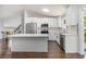 Modern kitchen with stainless steel appliances, white cabinets, and center island at 4835 Kellys Mill Nw Dr, Lilburn, GA 30047