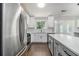 Modern kitchen featuring white cabinetry, stainless steel appliances and an island at 4835 Kellys Mill Nw Dr, Lilburn, GA 30047