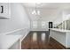 Open-concept living area with modern lighting, wood floors, and staircase at 4835 Kellys Mill Nw Dr, Lilburn, GA 30047
