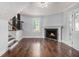 A comfortable living room features hardwood floors, fireplace, and a window that provides natural light at 4835 Kellys Mill Nw Dr, Lilburn, GA 30047