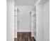 A walk-in closet with built-in shelves and laminate floors offers ample storage space at 4835 Kellys Mill Nw Dr, Lilburn, GA 30047