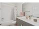 Fresh bathroom offers a shower-tub with subway tile, a grey vanity, and a framed mirror at 635 Holcomb Bridge Rd, Norcross, GA 30071