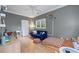 Bright bedroom with hardwood floors, ceiling fan, and a comfortable seating area at 635 Holcomb Bridge Rd, Norcross, GA 30071