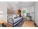 Comfortable bedroom with a daybed, desk, and a serene nature-themed wall hanging at 635 Holcomb Bridge Rd, Norcross, GA 30071