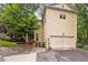 Home exterior featuring a two-car garage, landscaped yard, and a welcoming porch at 635 Holcomb Bridge Rd, Norcross, GA 30071