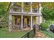 Inviting home with a covered front porch featuring decorative columns, a small garden, and a well-maintained lawn at 635 Holcomb Bridge Rd, Norcross, GA 30071