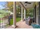 Covered brick front porch with outdoor furniture and decorative columns, perfect for relaxing outdoors at 635 Holcomb Bridge Rd, Norcross, GA 30071