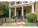 Inviting home with a charming fenced front porch, column supports, and comfortable outdoor seating at 635 Holcomb Bridge Rd, Norcross, GA 30071