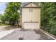 Rear exterior view of home with a spacious two-car garage and paved driveway at 635 Holcomb Bridge Rd, Norcross, GA 30071