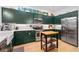 Well-equipped kitchen with stainless steel appliances, subway tile backsplash, and dark green cabinets at 635 Holcomb Bridge Rd, Norcross, GA 30071