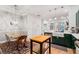 Open-concept kitchen featuring stainless steel appliances, custom cabinetry, and dining space with bright light at 635 Holcomb Bridge Rd, Norcross, GA 30071
